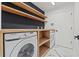 Efficient laundry room with shelving, Samsung washer/dryer, and stylish flooring at 1608 Ledgestone Dr, Brandon, FL 33511