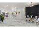 Spacious living area with elegant marble floors, opening to a kitchen and dining space with access to the lanai at 1608 Ledgestone Dr, Brandon, FL 33511
