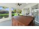 Enclosed porch features a hot tub, a ceiling fan, and views of the backyard at 1608 Ledgestone Dr, Brandon, FL 33511
