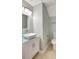 Bright bathroom features a modern vessel sink, updated vanity, and neutral tile flooring at 18228 Paradise Point Dr, Tampa, FL 33647