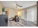 Bedroom features hardwood floors, ceiling fan, and closet space with a dark leather chair and ottoman at 18228 Paradise Point Dr, Tampa, FL 33647
