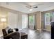 Comfortable bedroom features two closets, a ceiling fan, and a cozy chair with ottoman for relaxed living at 18228 Paradise Point Dr, Tampa, FL 33647