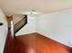 Spacious living room with stairs, wood floors, a modern light fixture, and a coat closet at 18228 Paradise Point Dr, Tampa, FL 33647