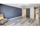 Spacious living room with modern flooring, accent wall, and access to the ensuite at 18228 Paradise Point Dr, Tampa, FL 33647