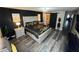 Luxurious primary bedroom with a statement wall, barn door access to the ensuite, and upscale finishes at 18228 Paradise Point Dr, Tampa, FL 33647