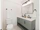 Modern bathroom with a double sink vanity, herringbone cabinets, and tiled floors at 1886 San Mateo Dr, Dunedin, FL 34698