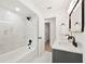 Bright bathroom featuring double sink vanity with marble countertop and modern, black fixtures at 1886 San Mateo Dr, Dunedin, FL 34698