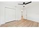 Bedroom with wood-look floors, a closet, and access to additional rooms, providing ample storage at 1886 San Mateo Dr, Dunedin, FL 34698