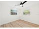 Bright bedroom with wood-look flooring and windows, providing a serene atmosphere at 1886 San Mateo Dr, Dunedin, FL 34698