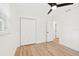 Bedroom with wood-look flooring, closet, and window for natural light at 1886 San Mateo Dr, Dunedin, FL 34698