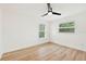Bright bedroom with wood-look flooring, two windows, and ample space, creating a cozy atmosphere at 1886 San Mateo Dr, Dunedin, FL 34698