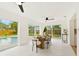 Bright dining room featuring marble floors, modern lighting, and sliding glass doors with pool views at 1886 San Mateo Dr, Dunedin, FL 34698