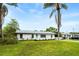 Recently renovated home exterior featuring a vibrant turquoise front door and modern windows at 1886 San Mateo Dr, Dunedin, FL 34698