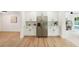 Renovated kitchen with stainless steel refrigerator, white cabinets, adjacent to the dining area and pool at 1886 San Mateo Dr, Dunedin, FL 34698