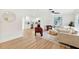 Bright living room featuring a plush sofa, modern decor, and open layout connecting to the kitchen at 1886 San Mateo Dr, Dunedin, FL 34698