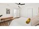 Spacious main bedroom with wood floors, bench seating, and a view to the kitchen at 1886 San Mateo Dr, Dunedin, FL 34698