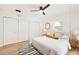 Bright main bedroom featuring wood floors, neutral tones, and a double door closet at 1886 San Mateo Dr, Dunedin, FL 34698