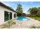 Backyard oasis featuring a kidney-shaped pool and tiled patio, perfect for outdoor enjoyment at 1886 San Mateo Dr, Dunedin, FL 34698