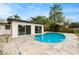 Backyard swimming pool and patio with sleek, modern, home with sliding glass doors to indoor/outdoor living at 1886 San Mateo Dr, Dunedin, FL 34698