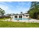 Backyard pool with white gravel, stone tile, and modern style Florida home at 1886 San Mateo Dr, Dunedin, FL 34698