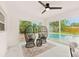 Cozy sitting area with stylish chairs and an outdoor view of the refreshing pool at 1886 San Mateo Dr, Dunedin, FL 34698