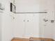 Clean utility room with wood floors and modern wall mounted appliances at 1886 San Mateo Dr, Dunedin, FL 34698