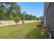Expansive backyard with lush green grass, mature trees, and a private wall, perfect for outdoor activities and relaxation at 19629 Fort King Run, Brooksville, FL 34601