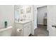 Bathroom vanity featuring a white countertop, mirror, toilet, and white cabinetry at 19629 Fort King Run, Brooksville, FL 34601