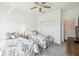 Bright bedroom featuring two beds, ceiling fan, and closet space at 19629 Fort King Run, Brooksville, FL 34601