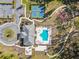 Aerial view of the community amenities featuring a pool, bocce ball court, tennis courts, and clubhouse at 19629 Fort King Run, Brooksville, FL 34601