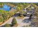 Beautiful community entrance featuring mature oak trees, lush landscaping, and a serene lake at 19629 Fort King Run, Brooksville, FL 34601