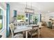 Dining room featuring a modern chandelier, large window, and stylish furniture with floral accents at 19629 Fort King Run, Brooksville, FL 34601