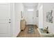 Welcoming entryway with wood floors, charming console table, and a decorative seashell rug, creating a coastal ambiance at 19629 Fort King Run, Brooksville, FL 34601