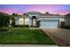 Charming one-story home with a well-maintained lawn, red brick driveway and pleasing blue exterior paint at 19629 Fort King Run, Brooksville, FL 34601