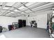 Spacious three car garage with epoxy floors and ample storage space, offering a practical and organized area at 19629 Fort King Run, Brooksville, FL 34601
