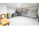Large garage with epoxy flooring, providing durability and style, along with room for storage and projects at 19629 Fort King Run, Brooksville, FL 34601