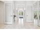 Bright hallway featuring white marble floors and modern design elements leading to outdoor views at 19629 Fort King Run, Brooksville, FL 34601