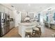 Bright kitchen featuring a center island with seating, stainless steel appliances, and dining area at 19629 Fort King Run, Brooksville, FL 34601