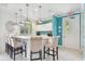Stylish kitchen bar area with pendant lighting, modern stools, and a view of outdoor greenery at 19629 Fort King Run, Brooksville, FL 34601