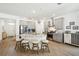 Bright kitchen featuring a center island with seating, stainless steel appliances and light grey cabinetry at 19629 Fort King Run, Brooksville, FL 34601