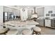 Bright kitchen featuring a center island with seating, stainless steel appliances and light grey cabinetry at 19629 Fort King Run, Brooksville, FL 34601