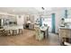 An open floor plan features the kitchen and dining areas, with ample natural light and neutral tones at 19629 Fort King Run, Brooksville, FL 34601
