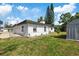 Fenced backyard with shed and lush greenery at 1979 E Skyline Dr, Clearwater, FL 33763