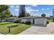 Inviting single-story home featuring a lush green lawn and well-kept landscaping at 1979 E Skyline Dr, Clearwater, FL 33763