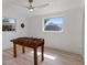 Bright game room with a foosball table and two windows, one of which overlooks the backyard at 1979 E Skyline Dr, Clearwater, FL 33763