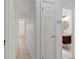 Bright hallway with doors leading to a bathroom at 1979 E Skyline Dr, Clearwater, FL 33763