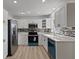 Modern kitchen with stainless steel appliances, white cabinets, and stylish backsplash at 1979 E Skyline Dr, Clearwater, FL 33763