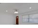 Bright living room with a modern ceiling fan, minimalist decor, and wood-look flooring at 1979 E Skyline Dr, Clearwater, FL 33763