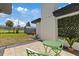 Outdoor patio area with green chairs, a shed, and landscaping at 1979 E Skyline Dr, Clearwater, FL 33763