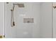 Shower with gold fixtures and a mosaic tile inset at 1979 E Skyline Dr, Clearwater, FL 33763